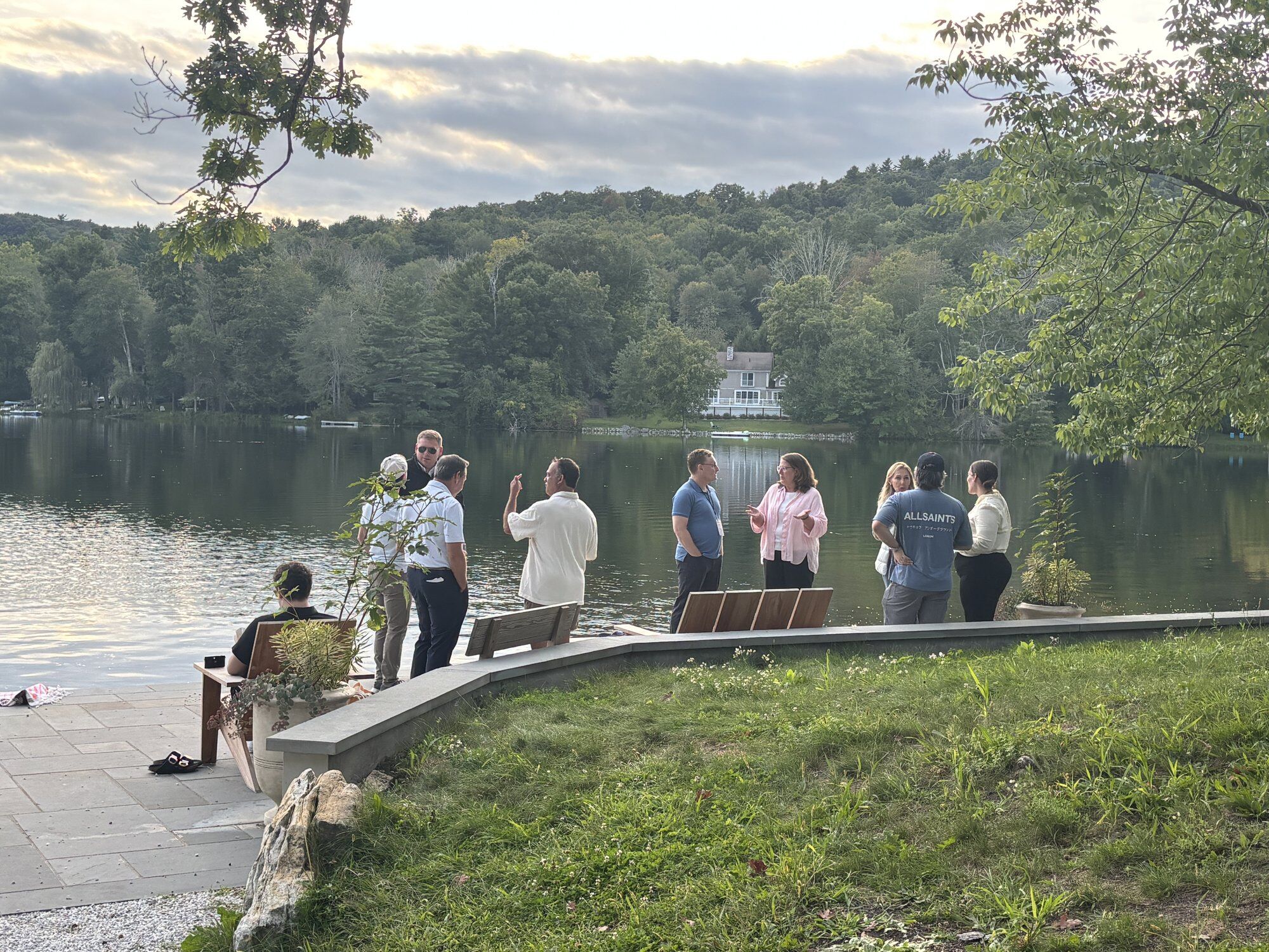 Attendees gather by the lake at dusk at The Prospect Berkshires