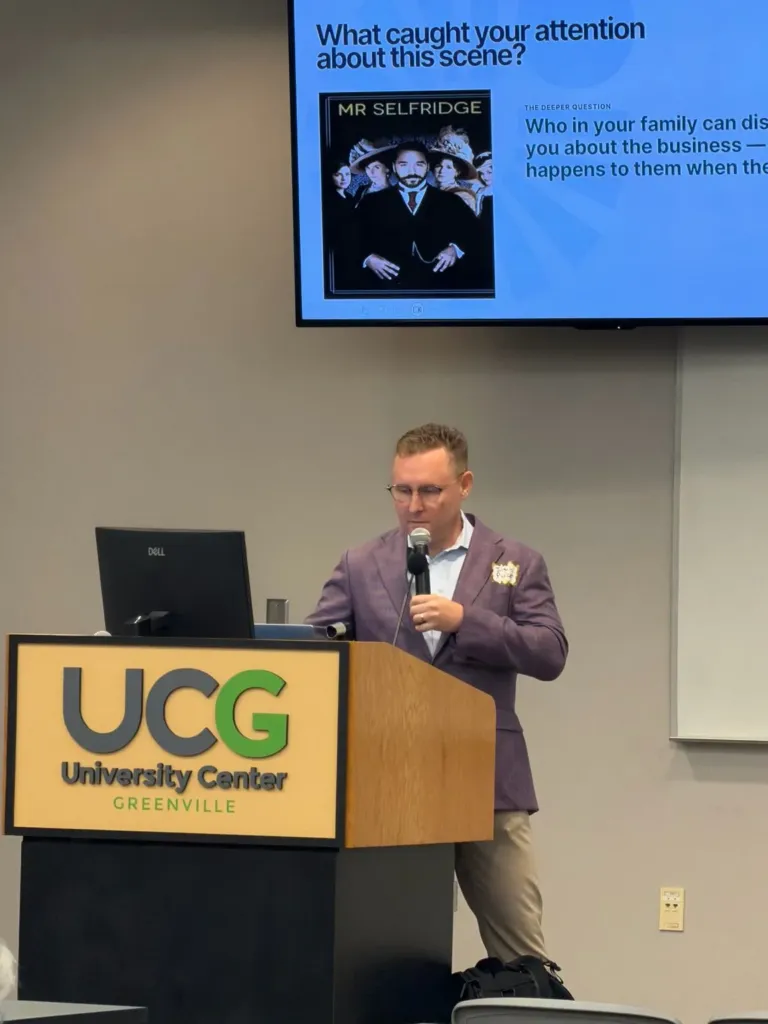 Jason Packer speaking at the University Center of Greenville podium during "18 Lessons from a 118-Year-Old Family Business"
